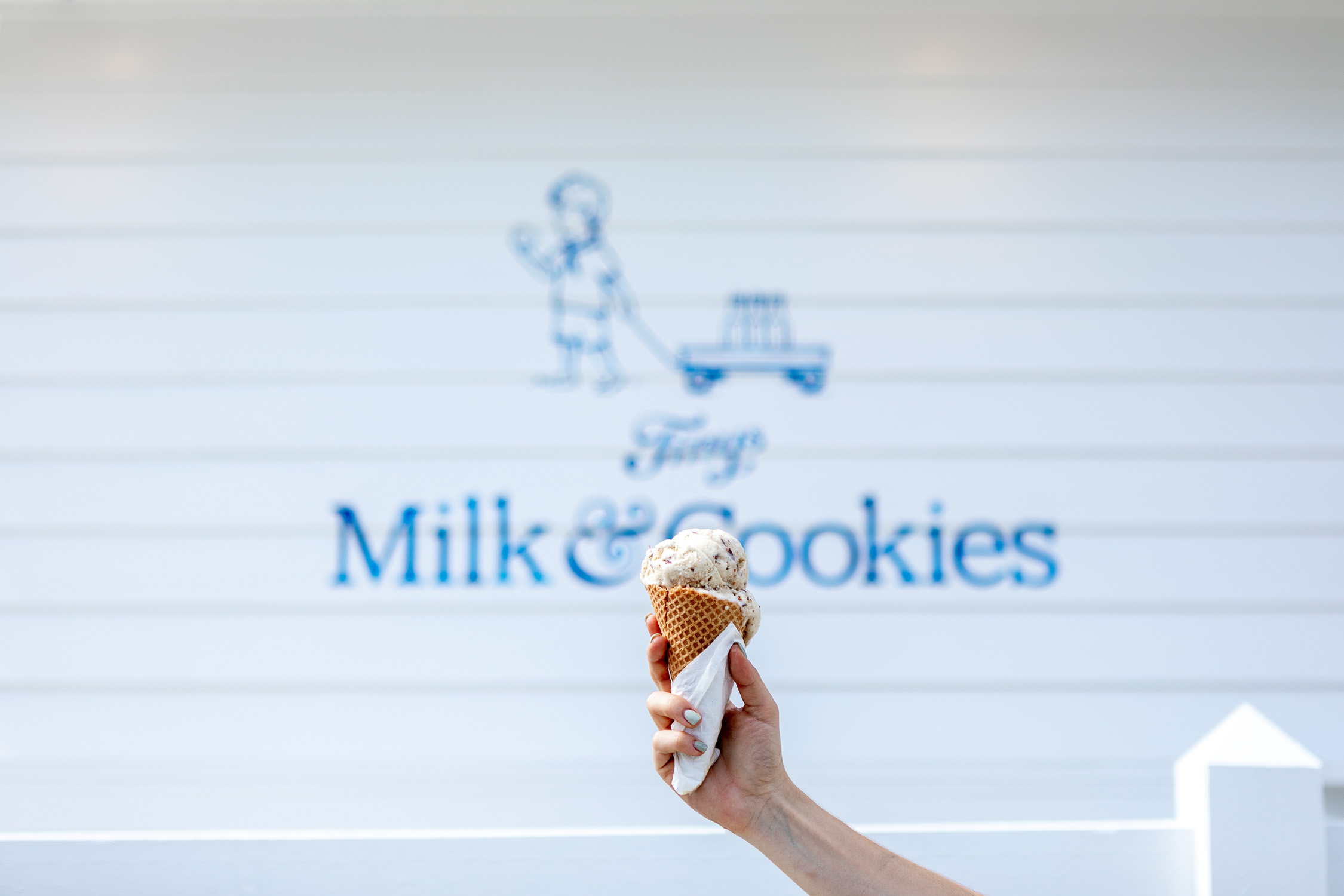 Logo mural with hand holding ice cream in front of it